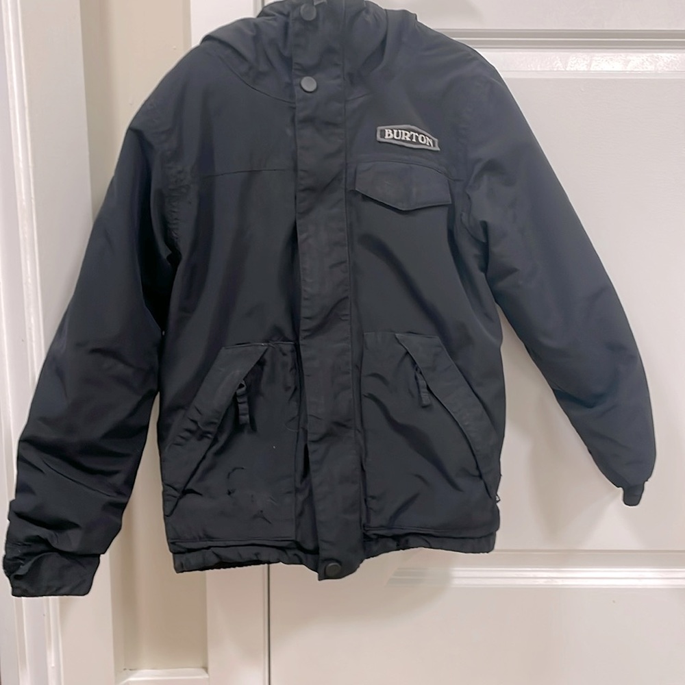 Size 6-7 boys winter jacket. Black jacket with multiple pockets and a hood.
